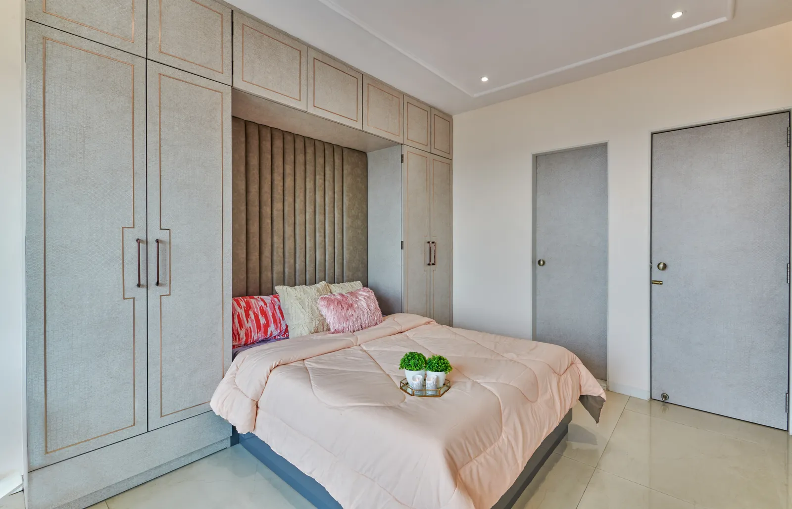 The sleek, paneled design of the wardrobe in Bedroom 1 is accentuated by delicate metallic trims, adding a touch of understated glamour.